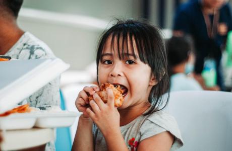 child eating sandwich