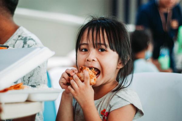 child eating sandwich